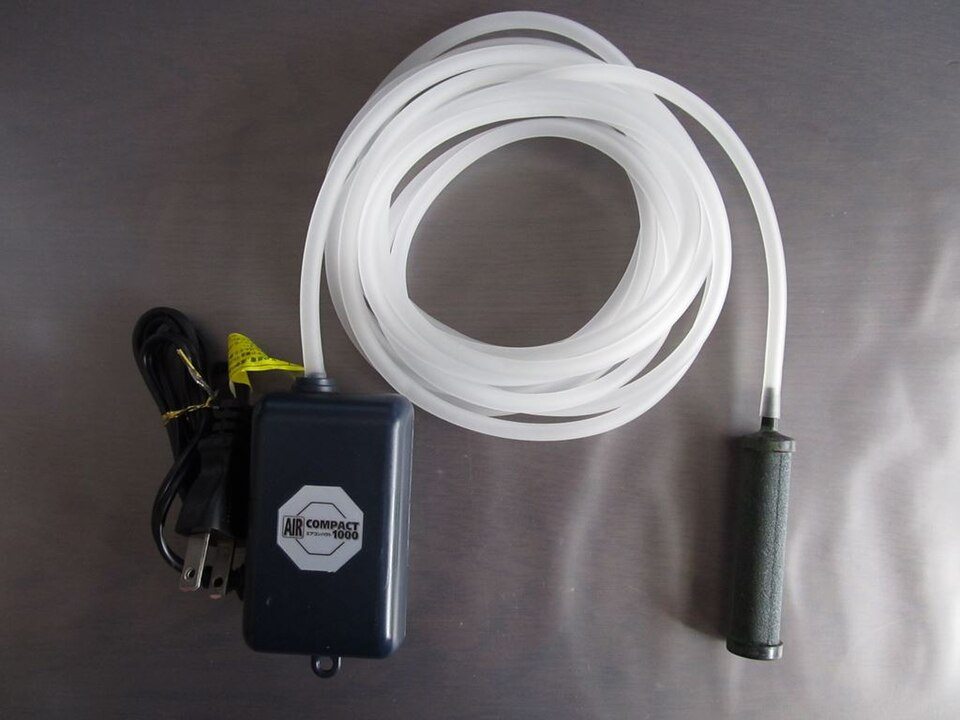 An aquarium air pump, tubing and air stone