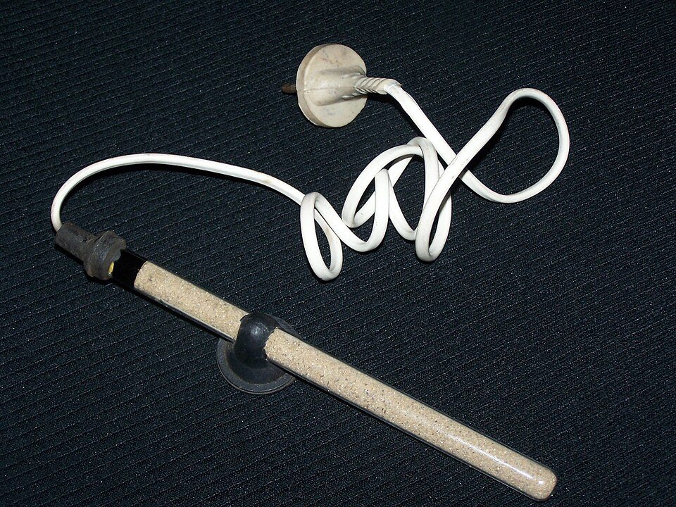 A glass-tube aquarium heater with its cable and suction-cup mounting.